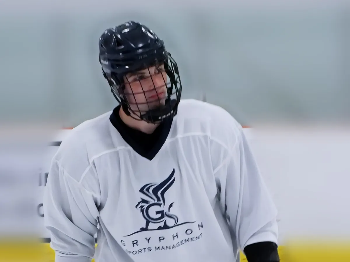 A player in a Gryphon Sports Management jersey on the ice