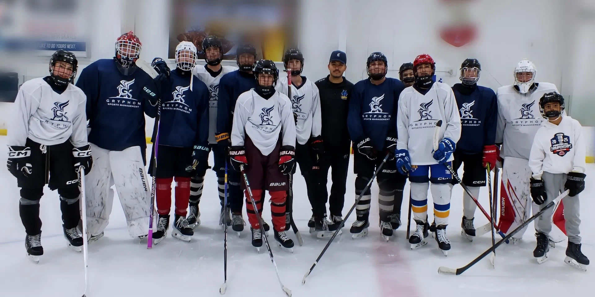 Players in Gryphon Sports Management jerseys lined up on the ice after a GSM prospect skate